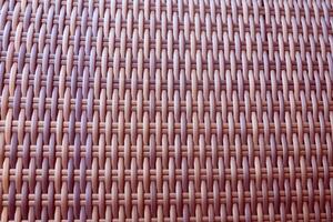 Synthetic rattan texture weaving background as used on outdoor photo