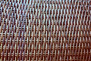 Synthetic rattan texture weaving background as used on outdoor photo