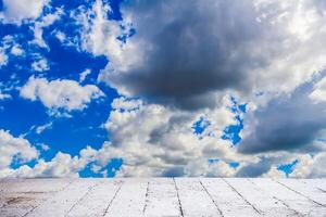 Dramatic cloudscape sky in summer day with cement floor photo