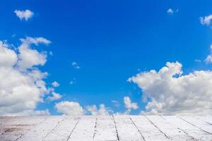 Blue sky with clouds and sun with cement floor photo
