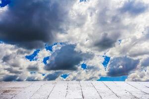 Dramatic cloudscape sky in summer day with cement floor photo