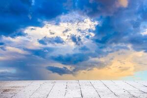 Dainty wispy pale salmon pink and golden yellow clouds at sunset and raining with cement floor photo