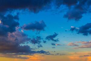 Dainty wispy pale salmon pink and golden yellow clouds at sunset photo