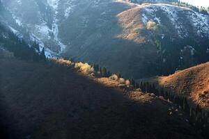 Autumn photo after snowfall, mountain lake Issyk in Almaty region, Kazakhstan. October.