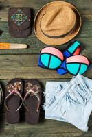 Mock up of summer traveling stuff on wooden board. photo