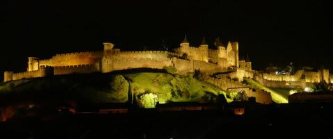 Night lights on the ramparts and castle towers of medieval Carcassonne photo