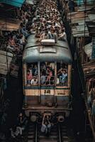 Crowds of Indian men at a commuter railroad station in Mumbai photo