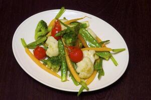 Asparagus and cauliflower with the tomatoes and the carrot photo