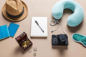 Packed suitcase of vacation items on wooden table, top view photo