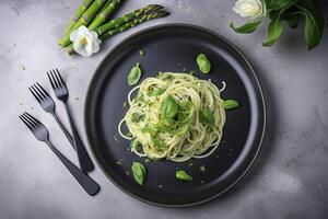 Traditional Italian spaghetti with asparagus in a herb sauce served as a top view on a Nordic design plate, generate ai photo