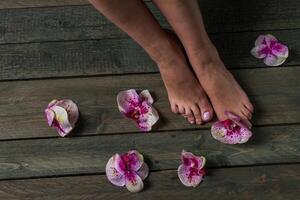 Care for beautiful woman legs with flower photo