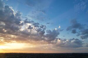 High Angle View of Luton City of England During Sunrise with Dramatical Clouds over Blue Sky. Image Was Captured with Drone's Camera on July 8th, 2023 photo