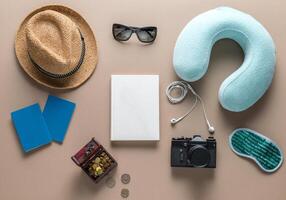 Packed suitcase of vacation items on wooden table, top view photo