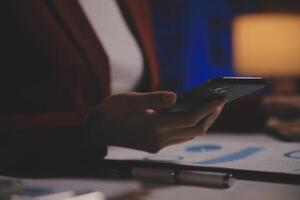 Business woman using calculator for do math finance on wooden desk in office and business working background, tax, accounting, statistics and analytic research concept photo