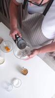 man using electric mixer whipping eggs for cream video