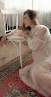 Beauty elegant bride wearing vintage bridal dress and posing at home in vintage interior video