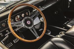 Vicenza Italy 19 March 2024 Detail shot of the vintage Shelby Mustang s dashboard and steering wheel showcasing luxury and control photo