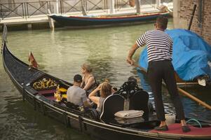 VENICE ITALY 25 MARCH 2019 Gondola in Venice with people on board photo