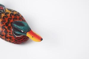 The typical Indonesian toy duck is made of wood and painted colors photo