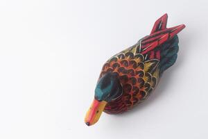 The Indonesian toy duck is made of wood and painted in attractive colors photo