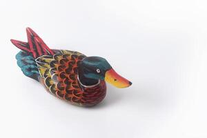 The Indonesian toy duck is made of wood and painted in attractive colors photo