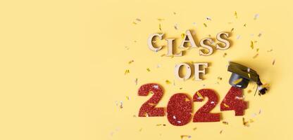 Class of 2024 banner concept. Red number 2024 with graduated cap and confetti top view photo