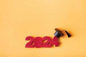 Red glitter number 2024 with graduated cap. Class of 2024 concept. photo