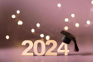 Number 2024 with graduated cap and bokeh lights. Class of 2024 concept photo