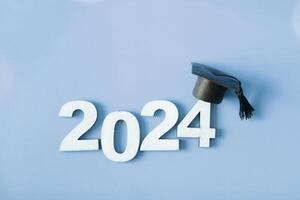 Wooden number 2024 with graduated cap. Class of 2024 concept. photo