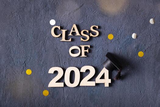 Class of 2024 concept. Number 2024 with graduated cap on dark background top view photo