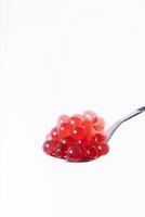 Close up of pink balls on spoon for making strawberry bubble tea photo