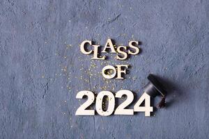 Class of 2024 concept. Number 2024 with graduated cap and confetti photo