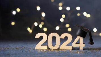 Class of 2024 concept. Number 2024 with graduated cap and bokeh lights banner. photo