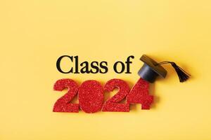 Red glitter number 2024 with graduated cap and Class of text. Class 2024 concept photo