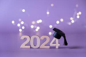 Number 2024 with graduated cap and bokeh lights. Class of 2024 concept photo