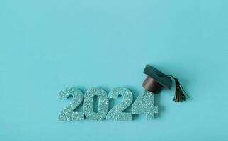 Golden glitter number 2024 with graduated cap. Class of 2024 concept. photo
