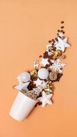 Mockup of coffee cardboard cups with Christmas decorations and coffee beans flat lay, top view on colored background. photo