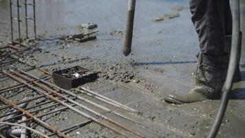 Vibration work with liquid concrete at the construction site video