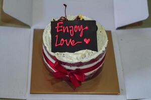 red velvet cake with enjoy love text decoration photo