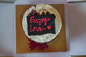 red velvet cake with enjoy love text decoration photo