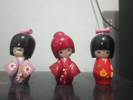 three small dolls with different colors and designs photo