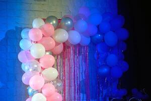 Festive blue shadow background with light pink balls.Space for text photo