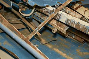 A pile of old scrap iron. Angles, pipes, slats, planks photo