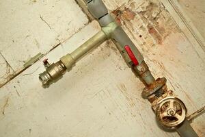 Plumbing. Sewerage. Water valve shutting off the water tap in the basement photo