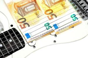 Fee. Two 50 euro banknotes on a rock electric guitar photo