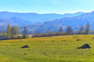 Mountain rural landscape with pasture,mountains in blue haze photo