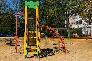 Summer spring children's playground with painted toy slide in park photo