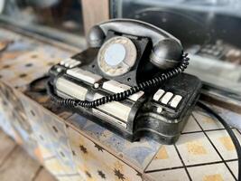Vintage telephone near house. Selective focus photo