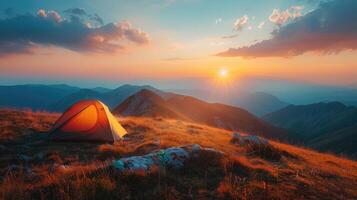 Sunset view with tent on mountain ridge photo