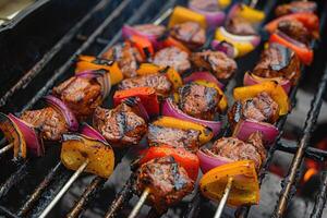 Skewers of meat on the grill with onions and peppers. photo